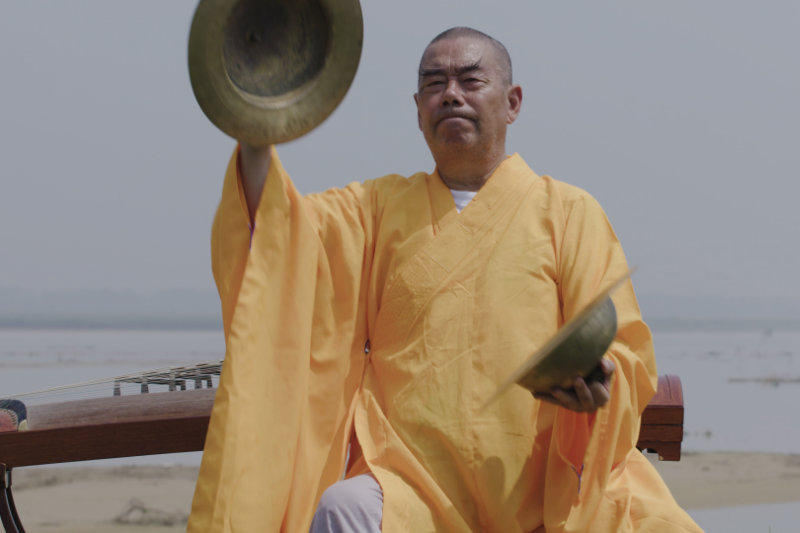 Elderly monk playing cymbals - Music Monks - THIS Buddhist Film Festival
