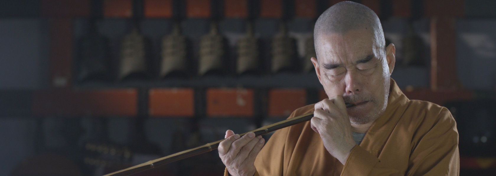 Elderly monk playing wind instrument - Music Monks - THIS Buddhist Film Festival